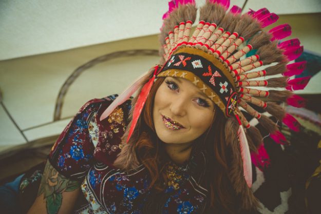 Karen in Indian headdress with glitter lips. Eco glitter.