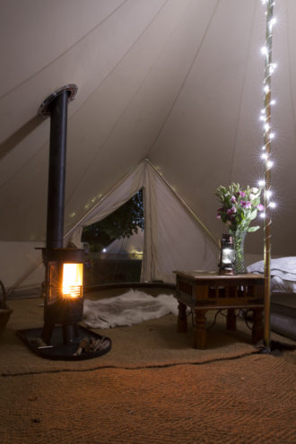 Interior of Snug wedding bell tent with log burner