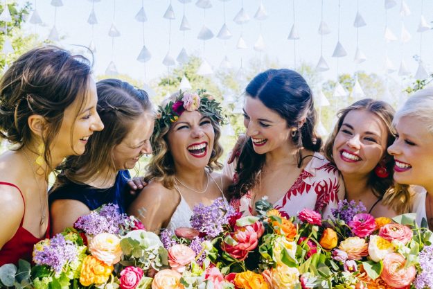 Bride with flower crown and bridesmaids at the Secret Barn