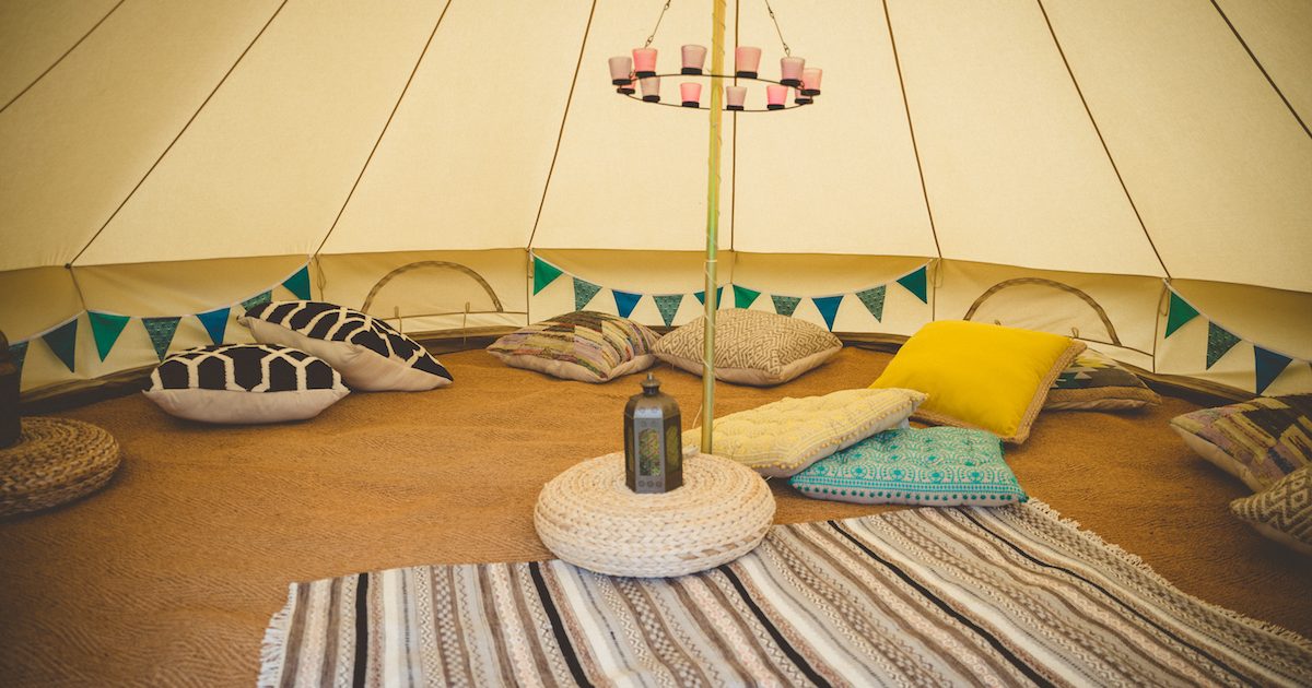 5m chill out bell tent with cushions, rugs and tea-light chandelier. Bell tents for chill out time in West Sussex.