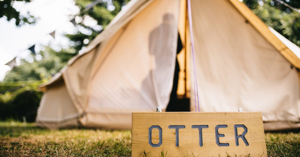 Wooden signage to front of bell tent. Bell tent hire for weddings.