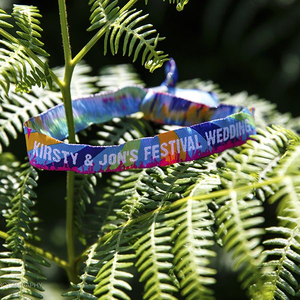 Festival wristband amongst ferns. Wedding inspiration. Bell tent hire Surrey
