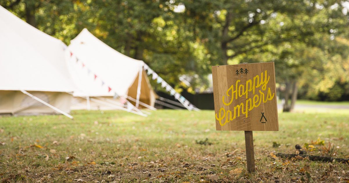 Happy campers sign Beautiful Bells glamping village and happy camper sign