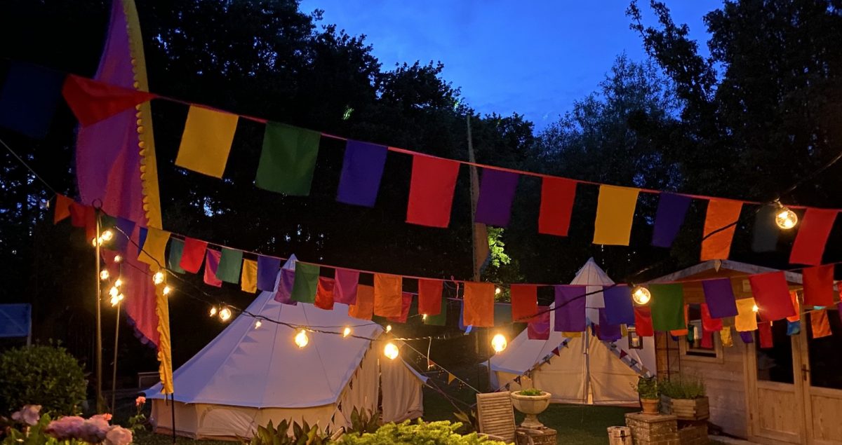 Garden glamping wiht festoons and bell tents and bunting. In Hampshire West Sussex and Surrey.